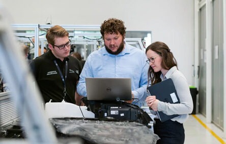 Three co-workers discussing the subject